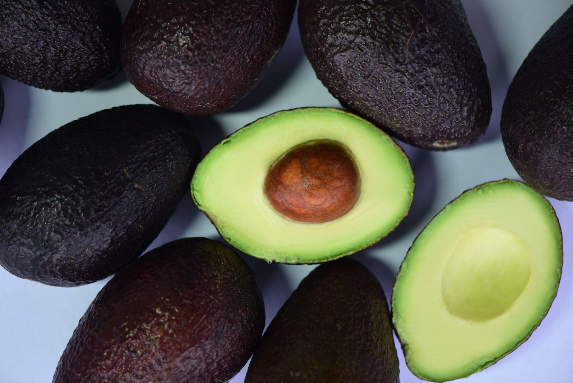 Ripe Hass avocados with two halves cut open. Photo: A Little Bit of Mercy by Lisa Ford